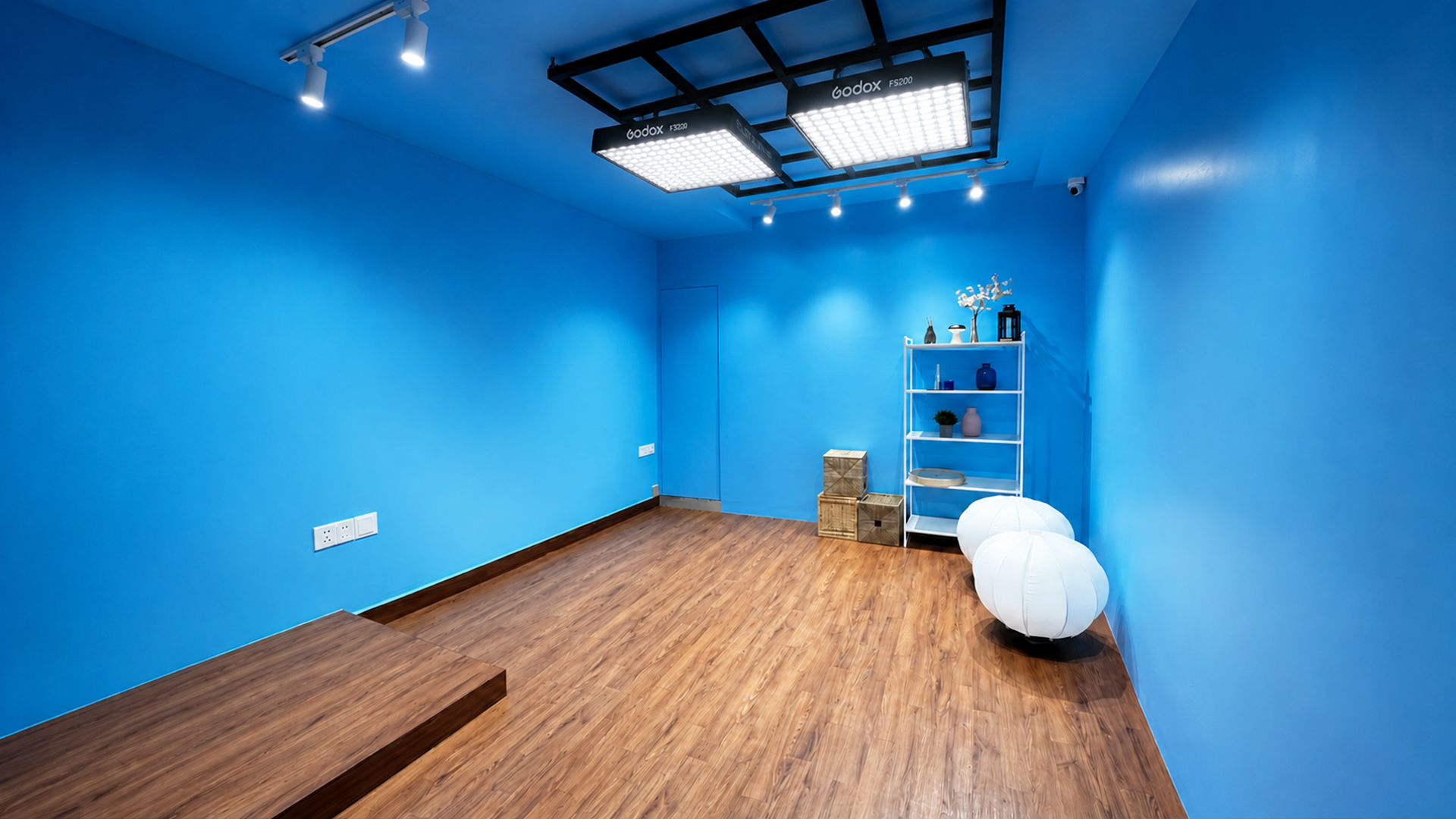 Blue-wall podcast production stage with professional lighting at Winterfox Studios